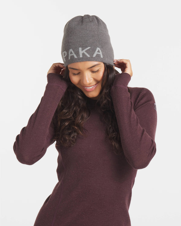 Woman in PAKA Beanie Smiling Wearing Uva / Dark Purple Alpaca Wool Thermal Baselayer Shirt Top – PAKA Apparel