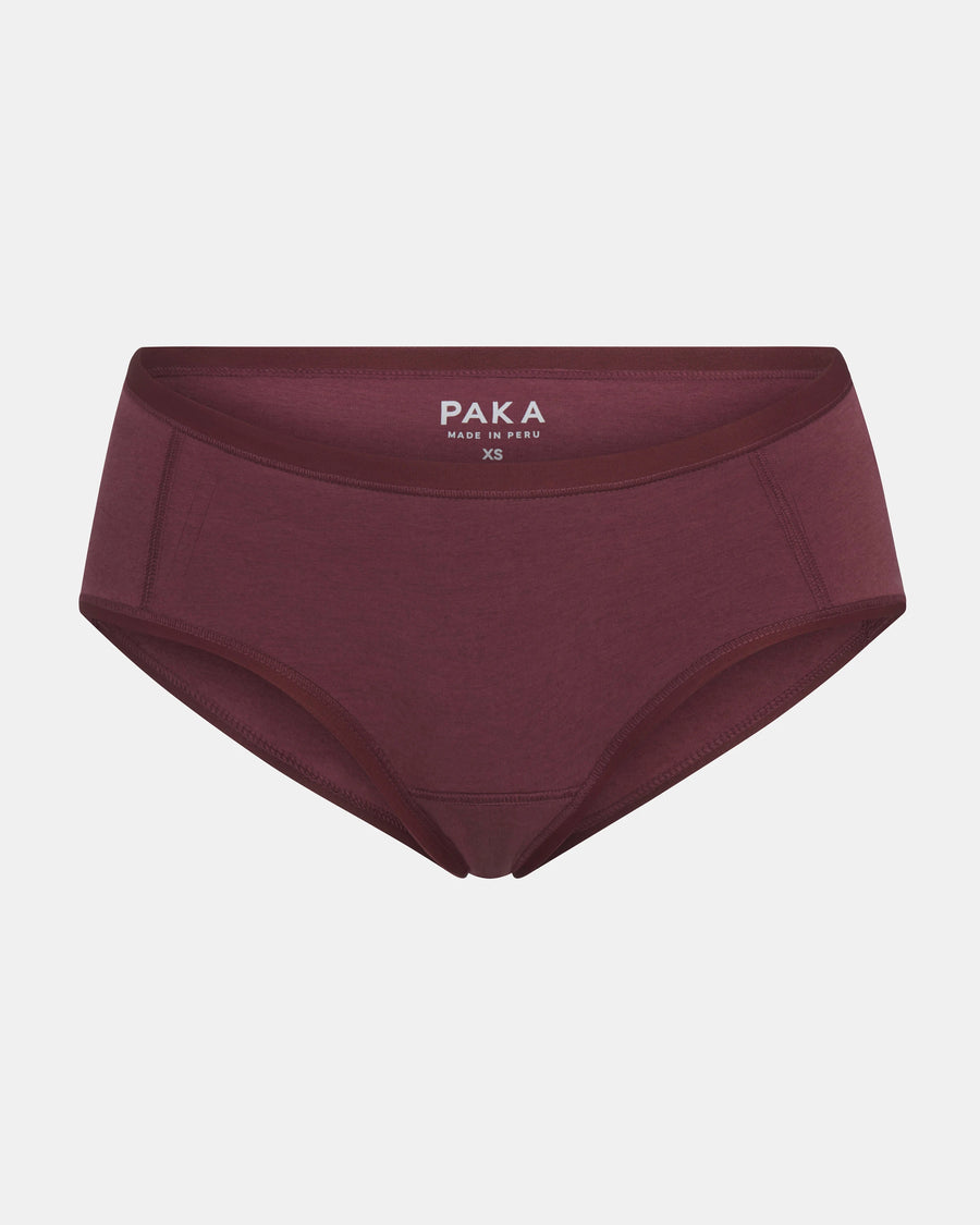 Front view of Women’s Essential Boy Short in raisin showing mid-rise full coverage with PAKA label on light gray background