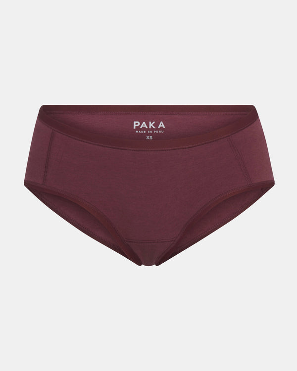 Front view of Women’s Essential Boy Short in raisin showing mid-rise full coverage with PAKA label on light gray background
