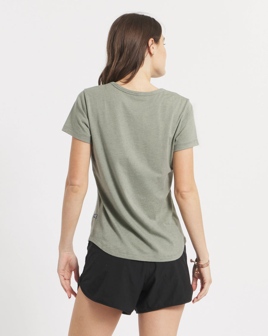 Back view of Women’s Essential Tee in willow showing short sleeves, crewneck, and curved hem on white background