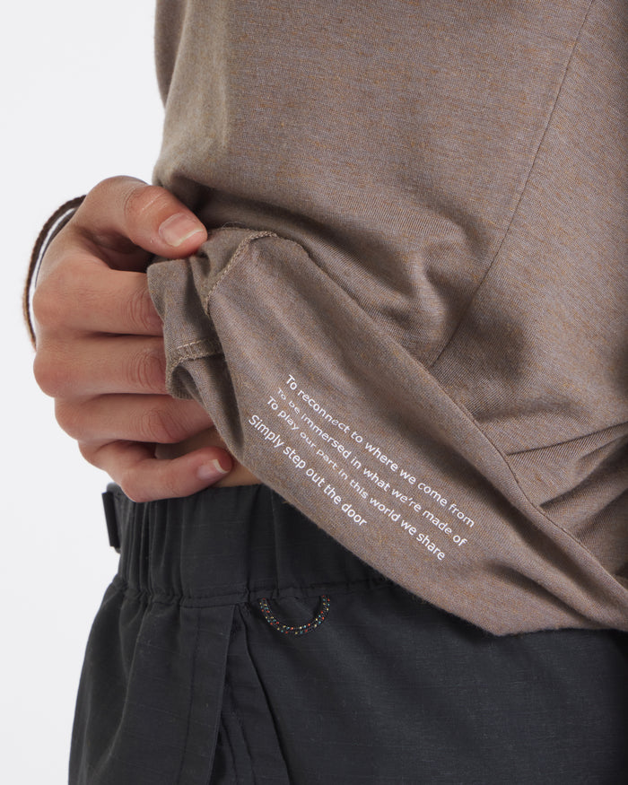 Close-up of Women’s Aire long sleeve in walnut showing white inner hem print Simply step out the door