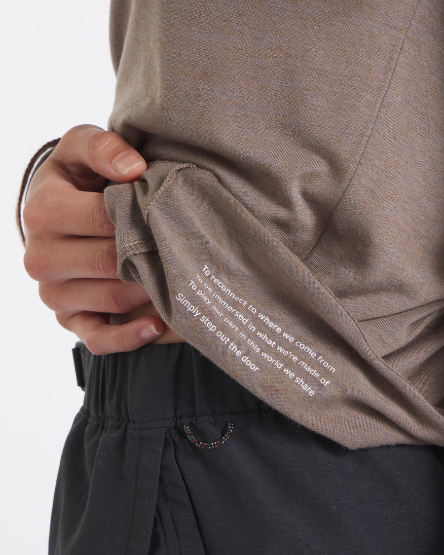Close-up of Women’s Aire long sleeve in walnut showing white inner hem print Simply step out the door