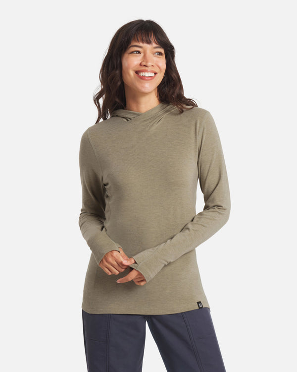 Front view of Women’s Sol Hoodie in elm green on model showcasing long sleeves with thumbholes and slim fit on white background