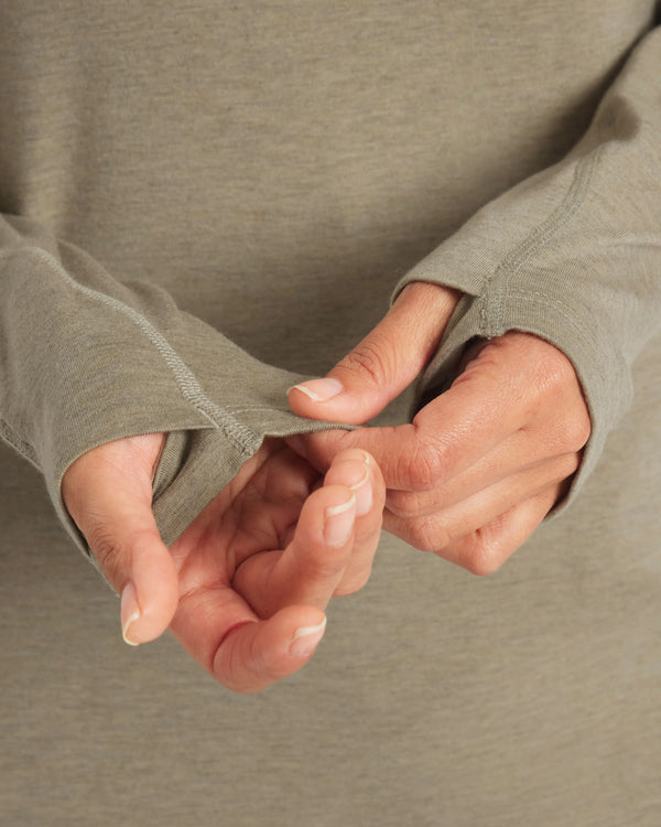 Close-up of Women’s Sol Hoodie sleeve in Elm showcasing hidden thumbhole and flatlock seams on neutral background