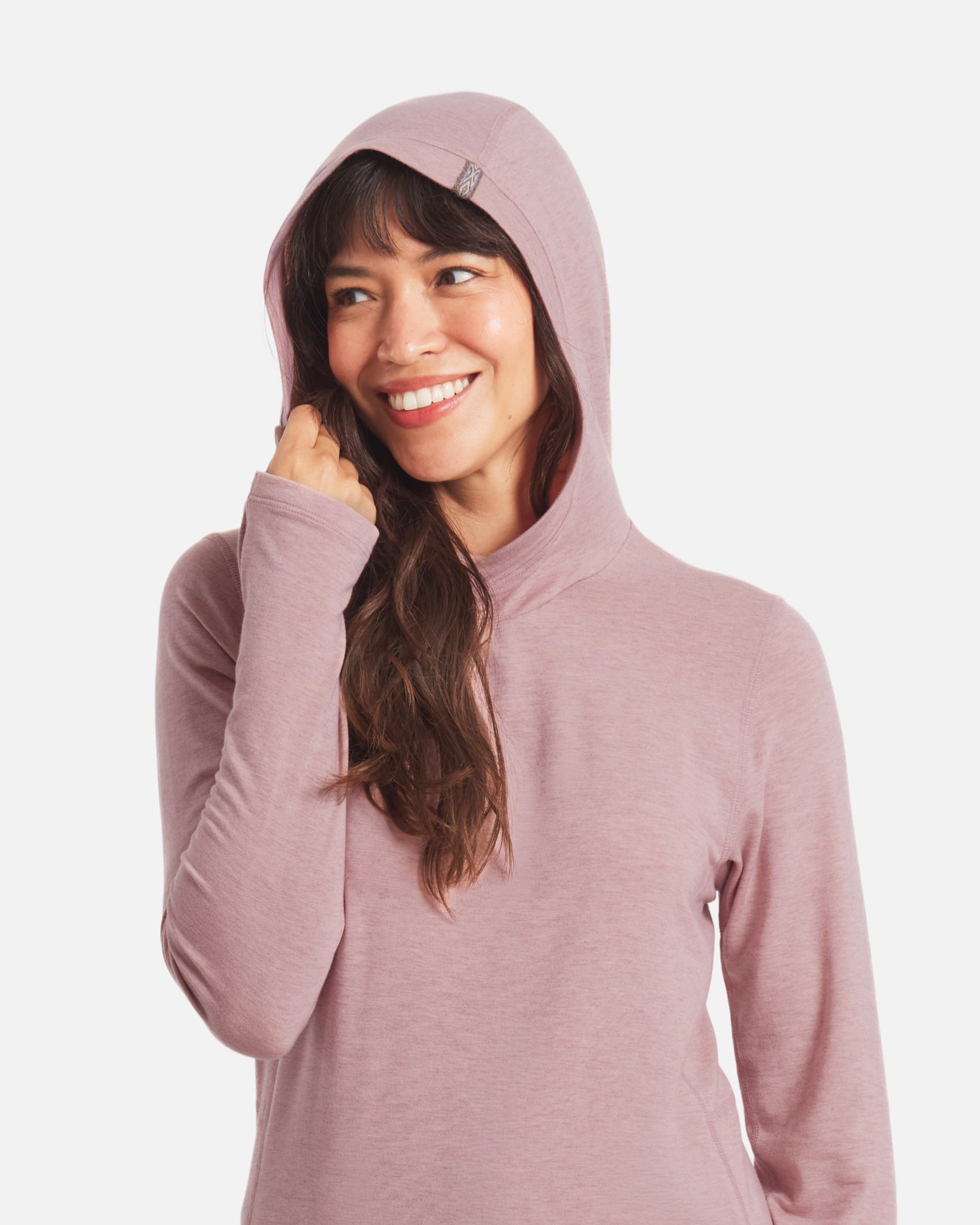 Front view of Women’s Sol Hoodie in Woodrose on model with hood up and visible thumbhole, regular fit, white background