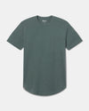 Front view of Women’s Essential Tee in Balsam showcasing crew neck and curved hem on light gray background