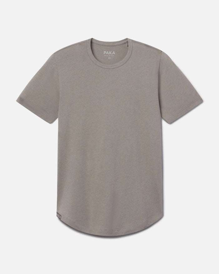 Front view of Women’s Essential Tee in stone showing crewneck, short sleeves, and curved hem on light gray background