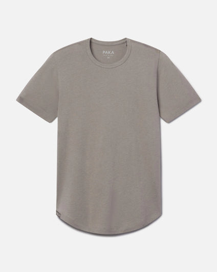 Front view of Women’s Essential Tee in stone showing crewneck, short sleeves, and curved hem on light gray background