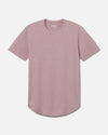 Front view of Women’s Essential Tee in woodrose showcasing curved hem and ribbed crewneck on light gray background