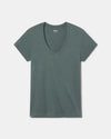 Flat lay of women’s V-neck tee showcasing deep V neckline and short sleeves in balsam green on a light gray background