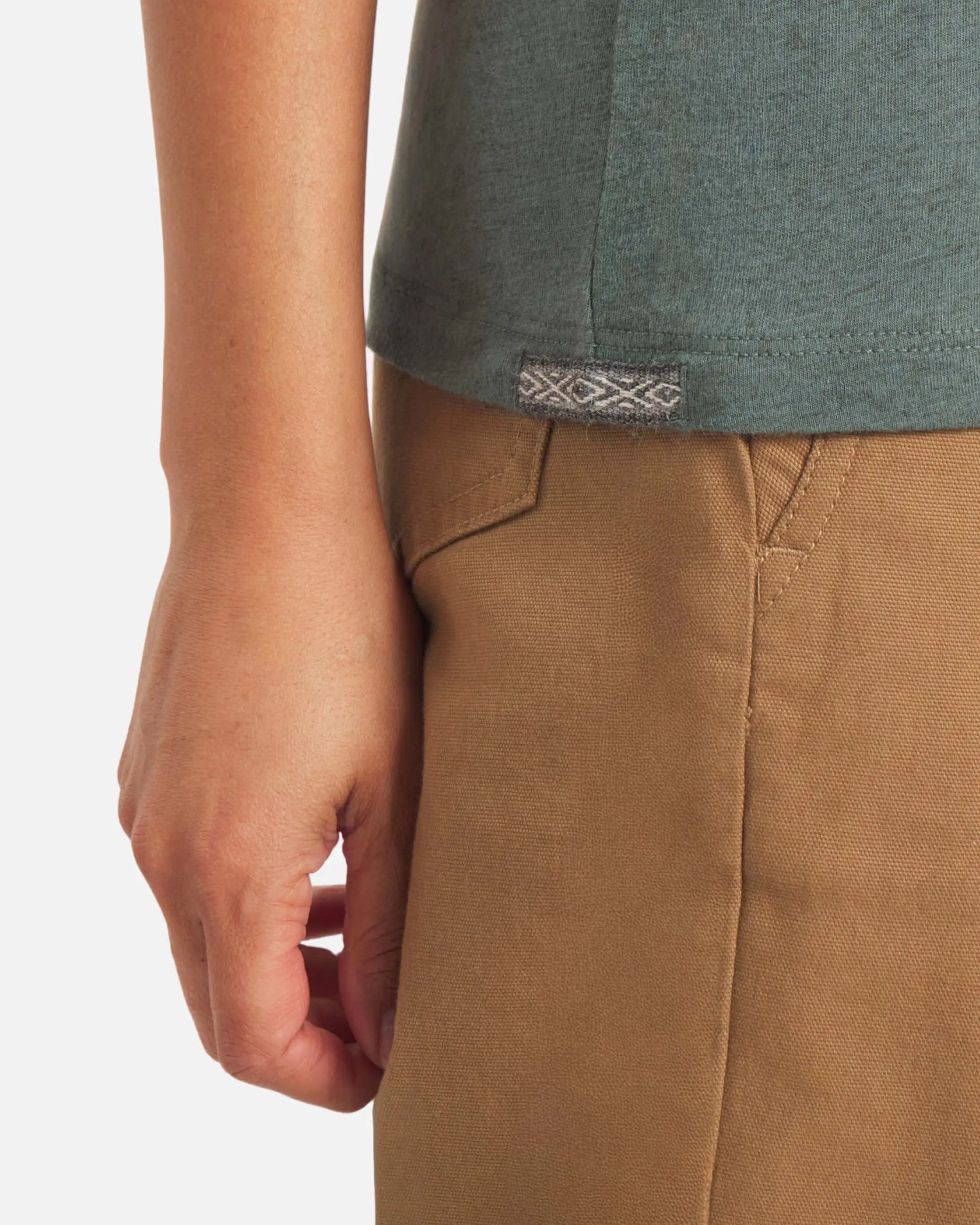 Close-up side view of Women’s Essential V-Neck t-shirt in balsam showing woven Inca ID tag and fabric texture