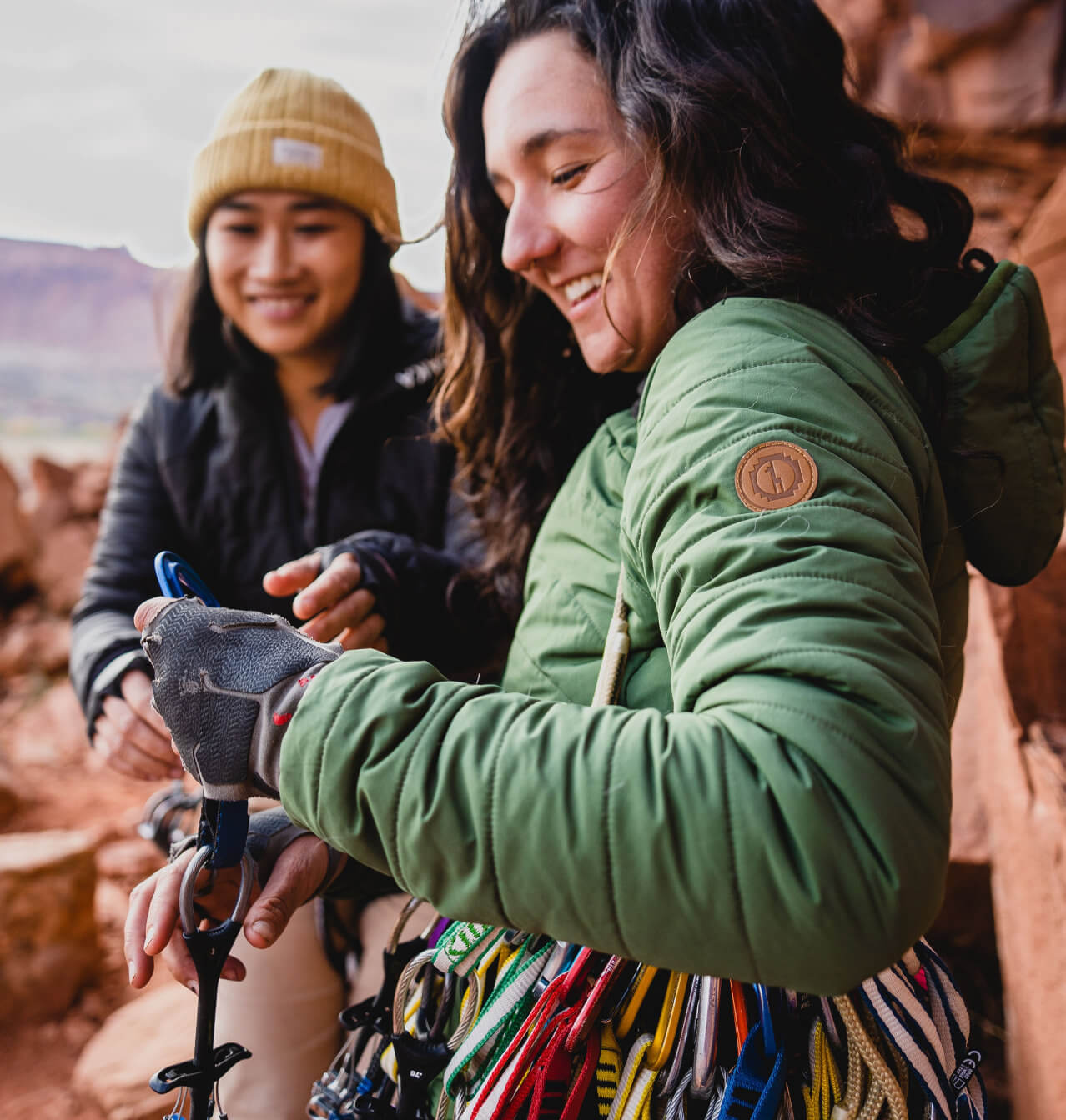 Climbers wearing a green and black jacket 