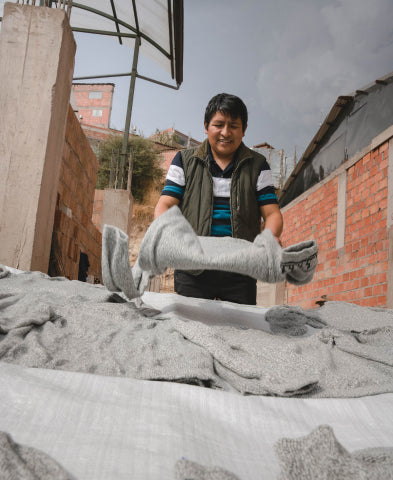 A man holding one of our Costa sweaters to air flat dry