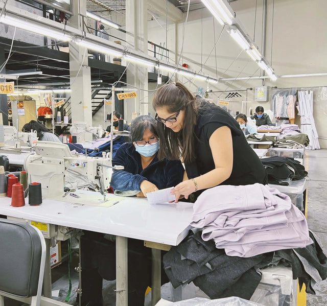 Gisella inspecting sweater in factory
