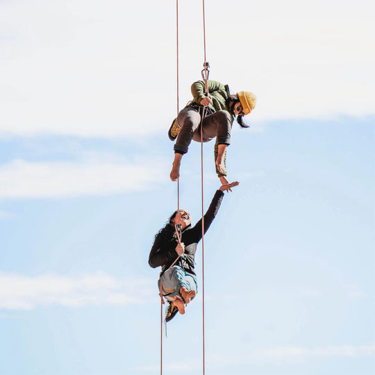 Two women suspended from a great height having fun together