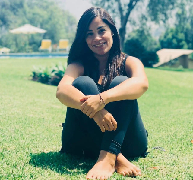 Gisella Garate, our Head of Peru smiling sitting on the grass