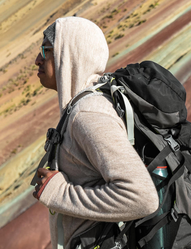 A backpacker in front of the Rainbow Mountain