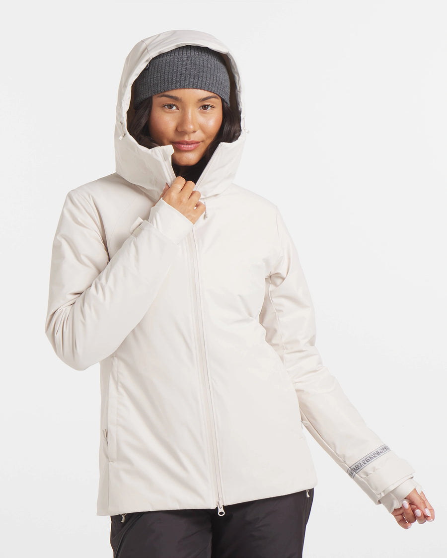 Front view of Women’s Apu Parka in white showcasing the hood up and zip-front on a plain light background