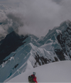 Climber on Peak of Snowy Mountain in Red Apu Puffer Jacket – PAKA Apparel