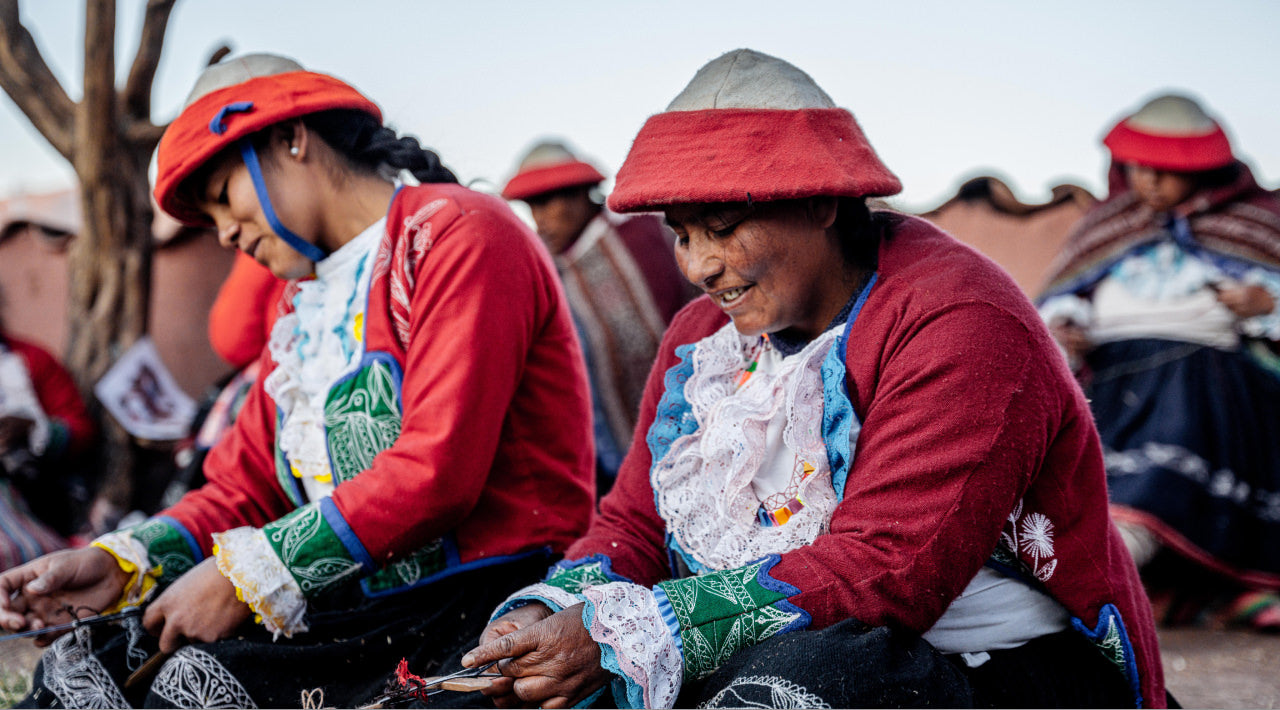 A group of Quechua women weaving alpaca bracelets
