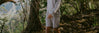 Man walking on a forest trail wearing tri-blend alpaca terry crew and matching terry shorts
