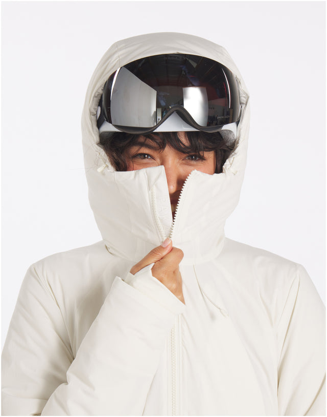 Front view of off-white insulated parka on model showing high zip-up collar and hood with mirrored goggles