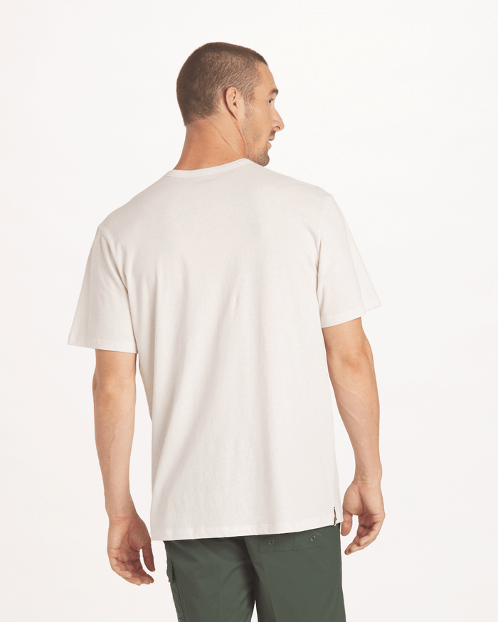 Back view of Men’s Tee in Wood (cream) showing relaxed fit on model against a light studio background