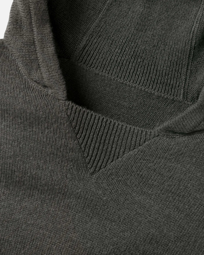 Close-up of The Hoodie alpaca hood and neckline showing ribbed V-insert and soft knit texture on white background