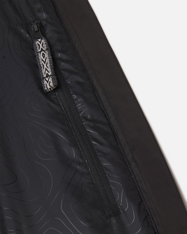 Close-up of women’s PAKAFILL Midweight Puffer interior showing zippered pocket with patterned pull tab on black lining