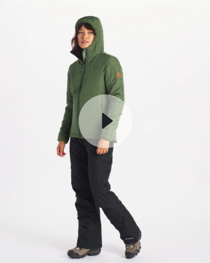 Three-quarter view of women’s PAKAFILL puffer jacket in green showing hood and quilted insulation on model against white