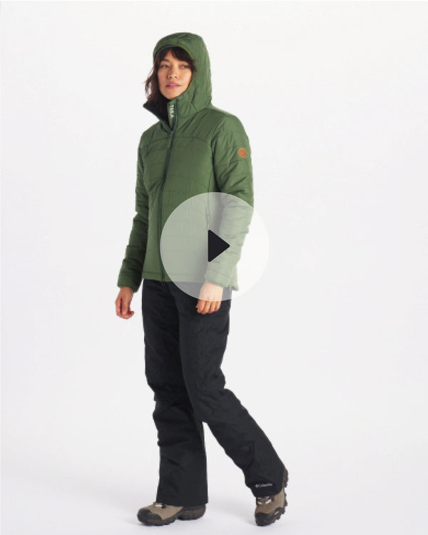 Three-quarter view of women’s PAKAFILL puffer jacket in green showing hood and quilted insulation on model against white